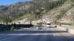 Tesla Semi is seen descending from a hill, passing by a diesel semi that is going in the same direction.配图